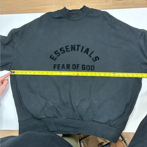 This is a Fear of God Essentials black sweatshirt. - Picture 4 of 7